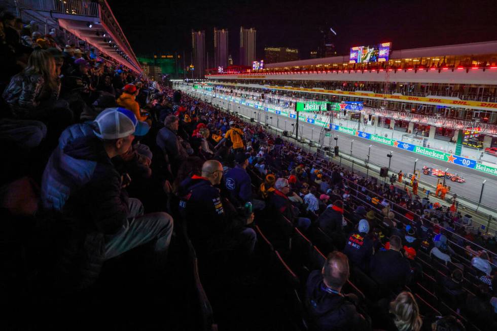 Fans sit in the grandstands as drivers zoom by during Formula 1 opening practice ahead of the F ...