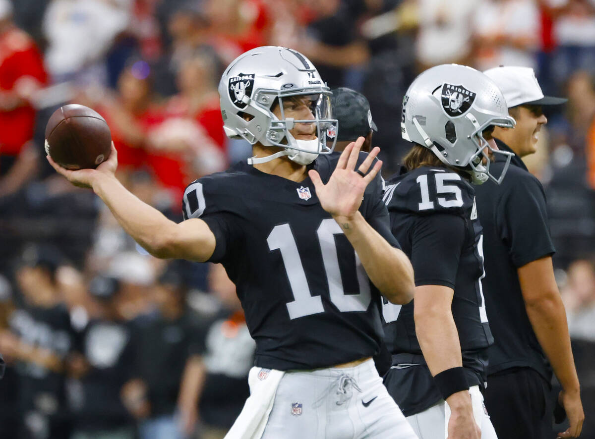 Raiders quarterback Desmond Ridder (10) throws the ball as he warms up prior to an NFL game aga ...