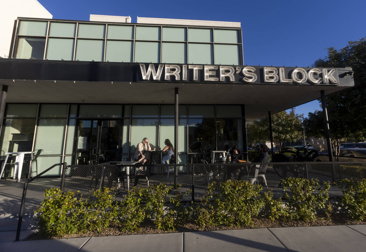 People sit outside the Writer’s Block, Wednesday, Nov. 13, 2024, in Las Vegas. (Daniel J ...