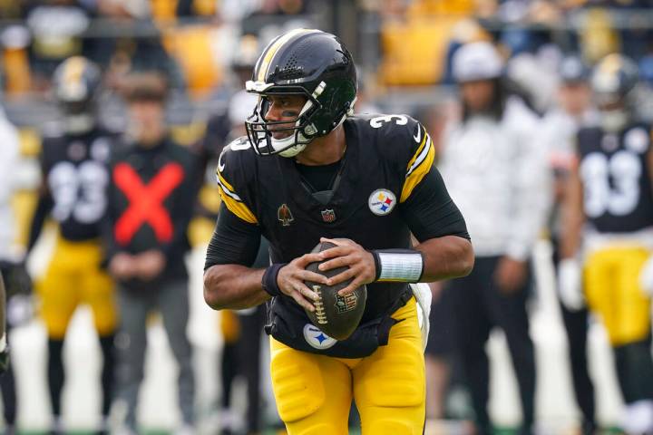 Pittsburgh Steelers quarterback Russell Wilson looks to pass against the Baltimore Ravens durin ...