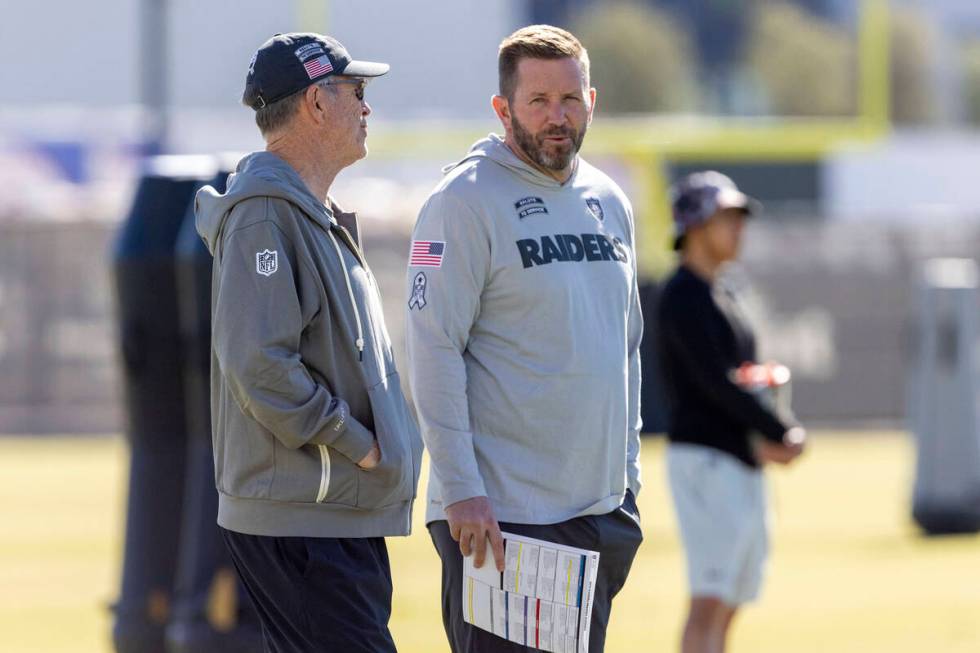 Raiders interim offensive coordinator Scott Turner, right, speaks with his father and senior of ...