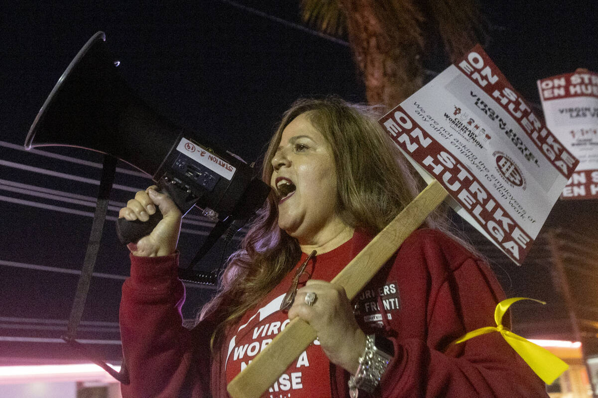 Culinary Workers Union members and Virgin Hotels workers chant and march along a picket line du ...