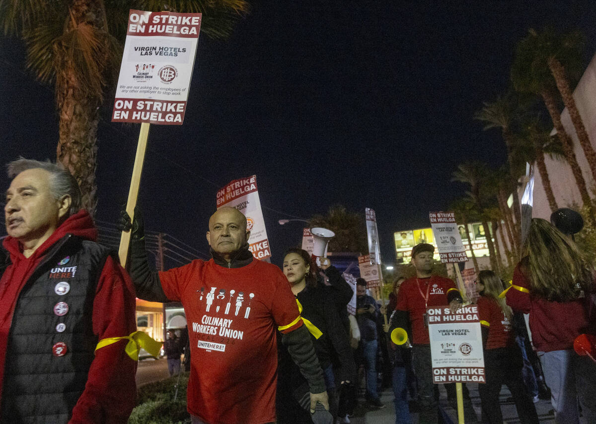 Culinary Workers Union members and Virgin Hotels workers march along a picket line during a pro ...