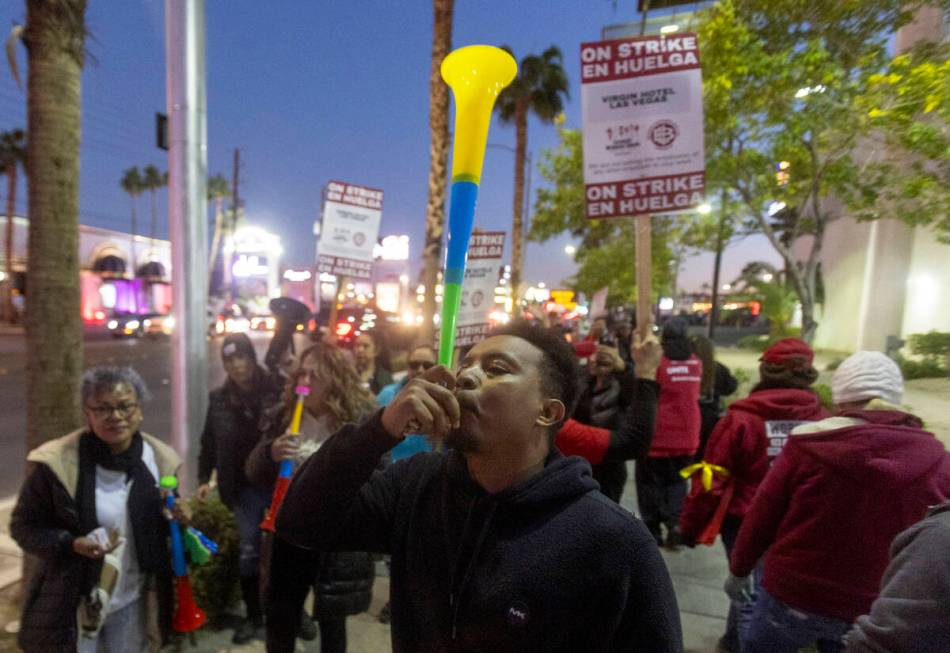 Culinary Workers Union members and Virgin Hotels workers blow horns and march along a picket li ...