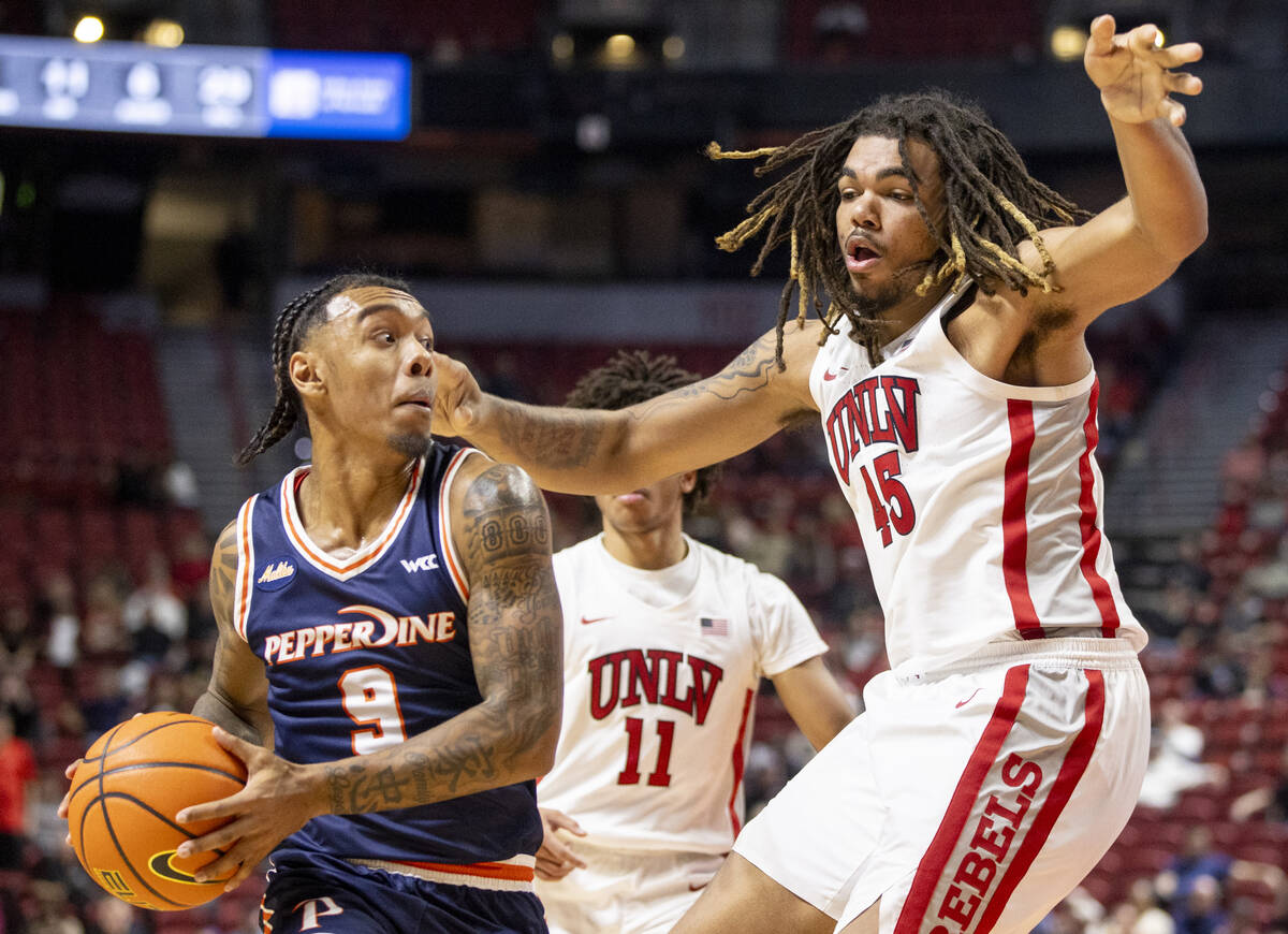 UNLV forward Jeremiah Cherry (45) defends Pepperdine Waves guard Taj Au-Duke (9) during the col ...