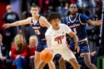 UNLV guard Dedan Thomas Jr. (11) passes the ball during the college basketball game against the ...