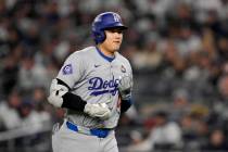 Los Angeles Dodgers' Shohei Ohtani walks to the dugout after a pop out against the New York Yan ...