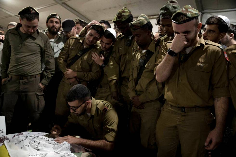 Israeli Defense Forces soldiers mourn at the grave of Sgt. First Class (res.) Roi Sasson, who w ...