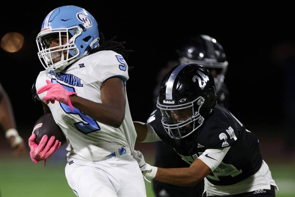 Centennial running back Khy Harris (5) carries the ball up the field while Desert Pines defensi ...