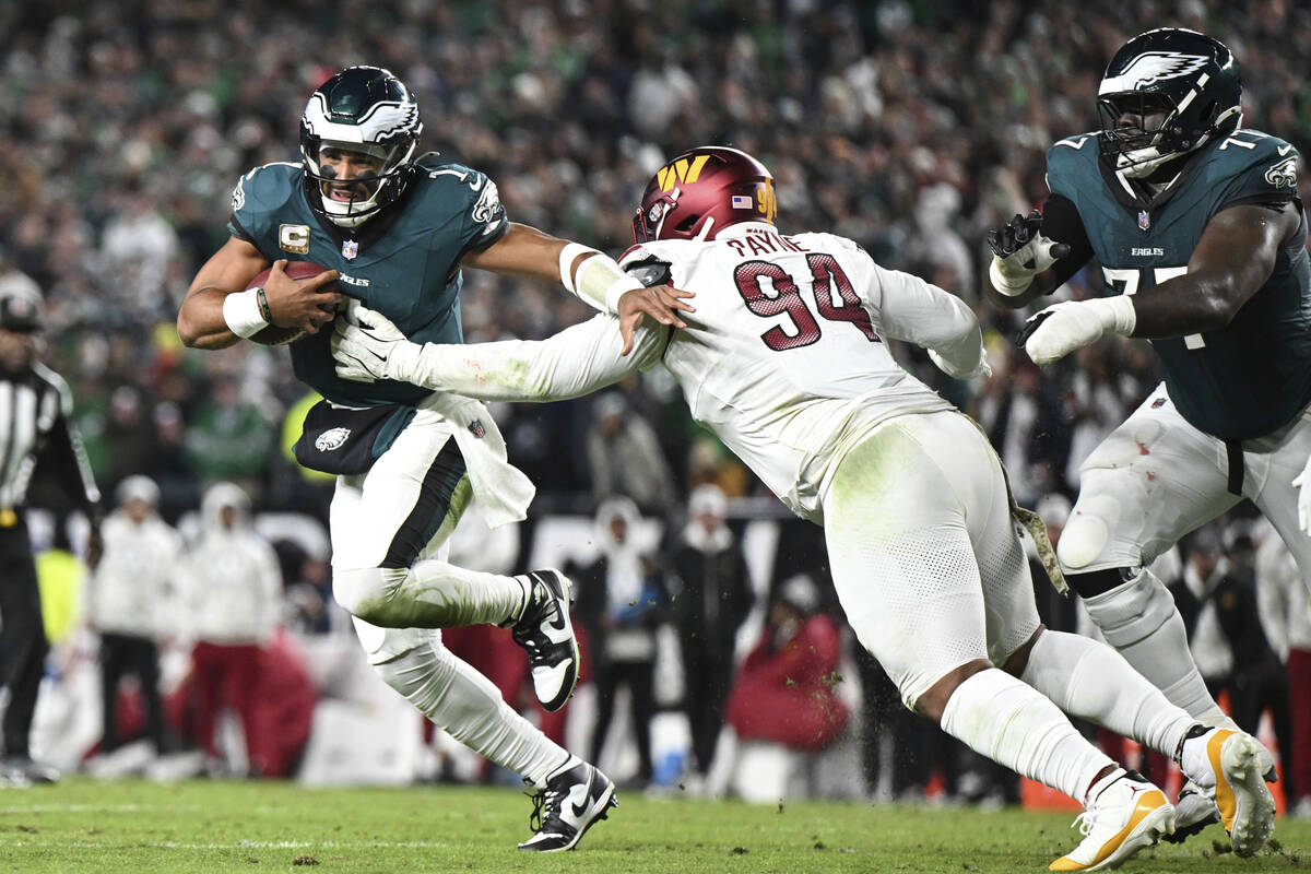 Philadelphia Eagles quarterback Jalen Hurts runs the ball and breaks away from Washington Comma ...