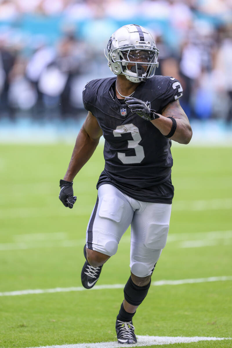 Las Vegas Raiders running back Zamir White (3) runs a play during an NFL football game against ...