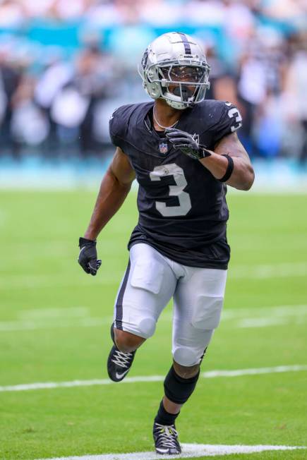 Las Vegas Raiders running back Zamir White (3) runs a play during an NFL football game against ...