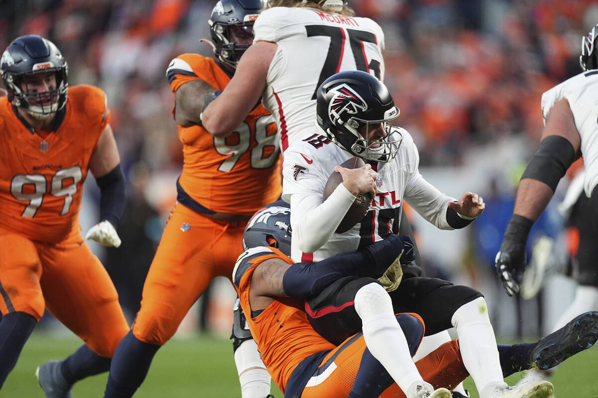 Atlanta Falcons quarterback Kirk Cousins (18) is sacked by Denver Broncos linebacker Nik Bonitt ...