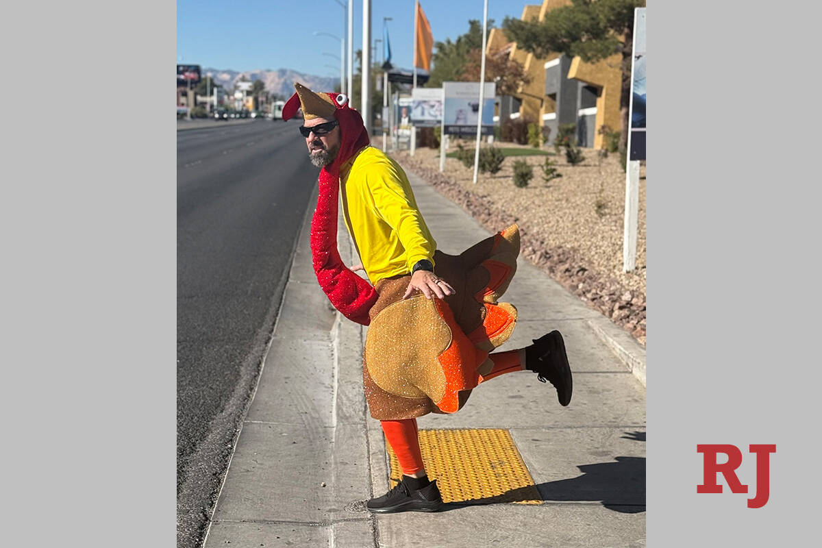 Clark County School District Police Officer Keith Habig prepares to walk with pedestrians while ...