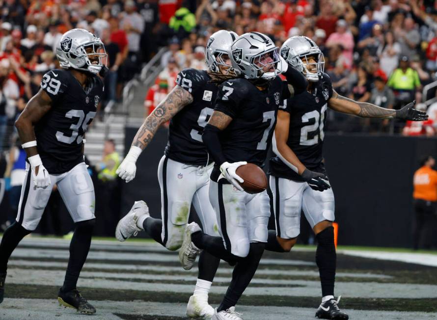 Raiders safety Tre'von Moehrig (7) celebrates his interception with cornerback Nate Hobbs (39) ...