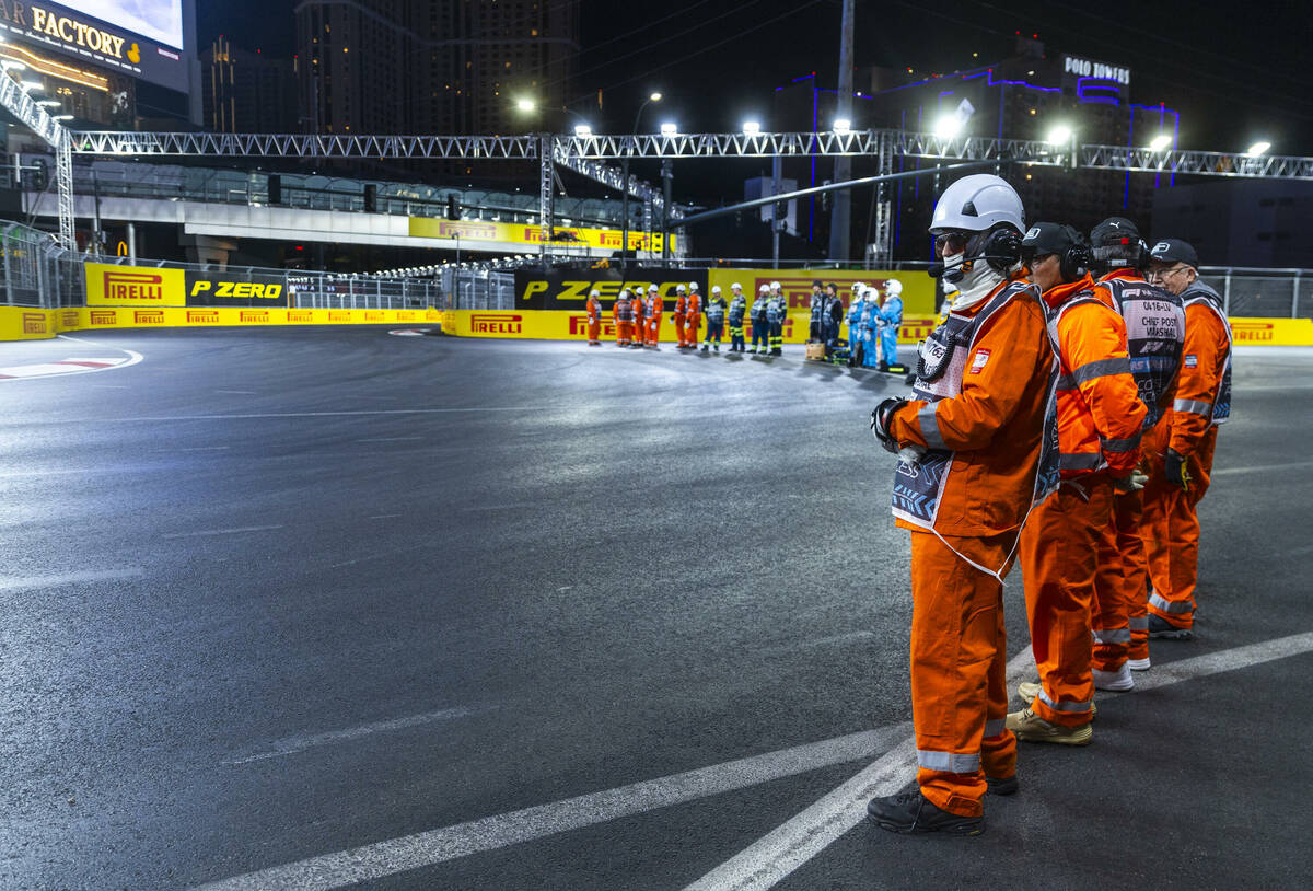 Track marshals line the track for the third practice round for the Formula 1 Las Vegas Grand Pr ...