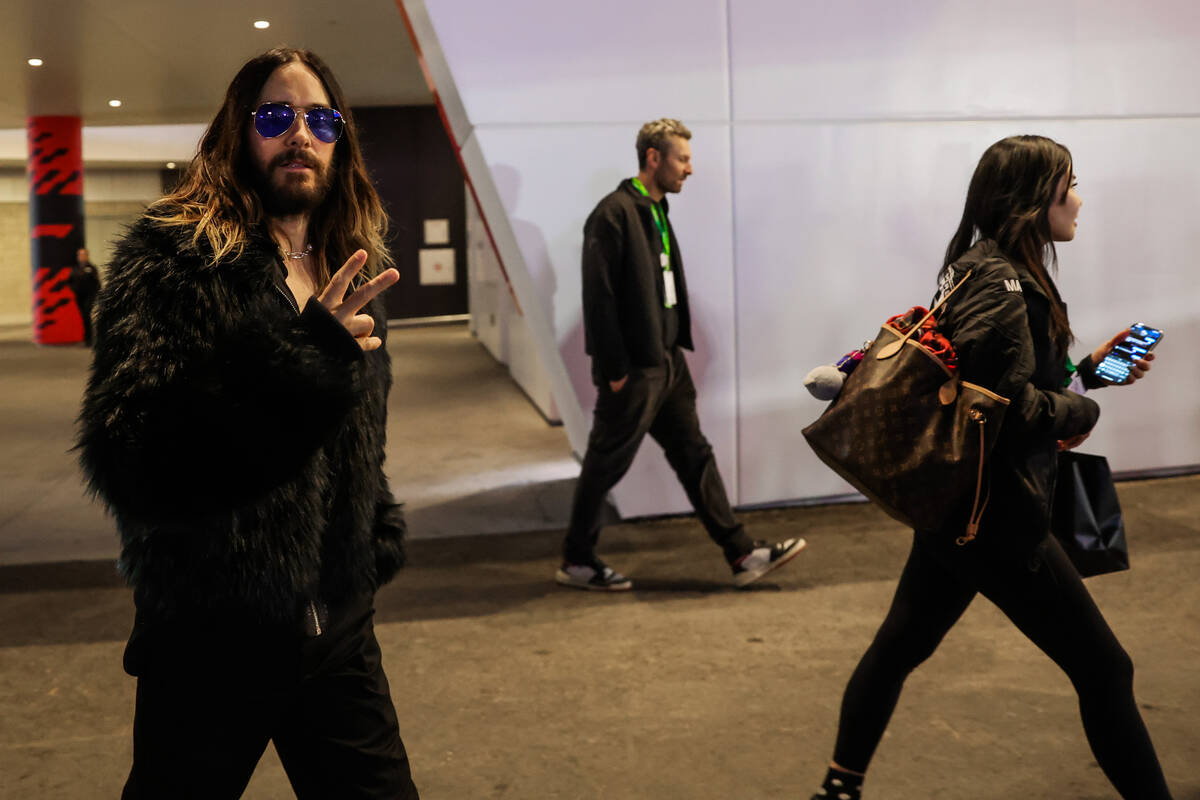 Actor and musician Jared Leto gives the peace sign while walking the Paddock during a qualifyin ...