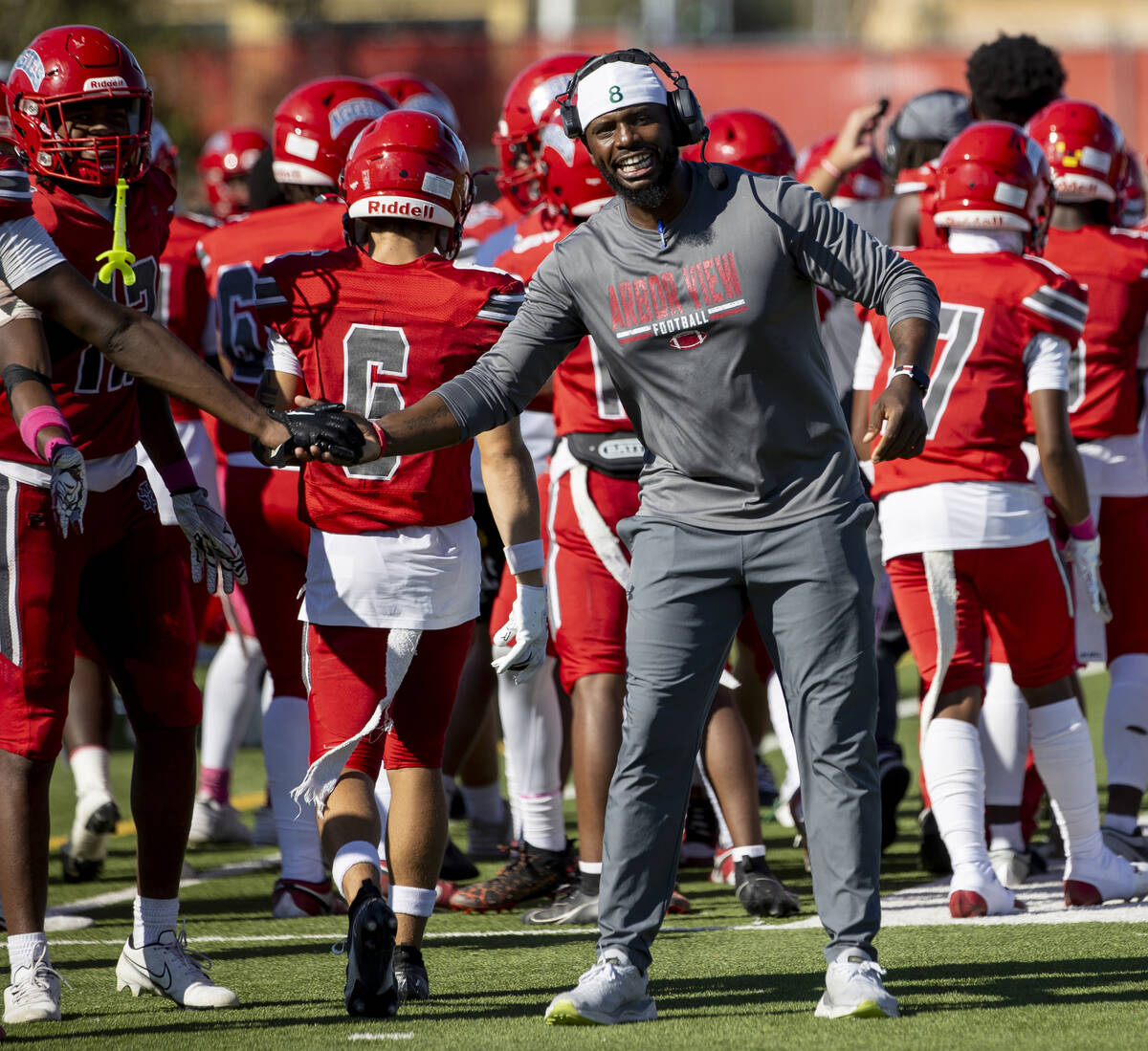 Arbor View Head Coach Marlon Barnett welcomes the offense back to the sideline after scoring a ...