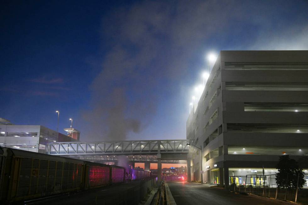 Firefighters work to put out a fire in a railcar carrying autos Friday, November 22, 2024, near ...