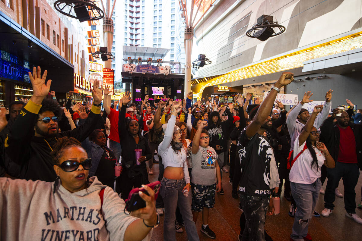 People march along the Fremont Street Experience during a rally for Brandon Durham, who was sho ...