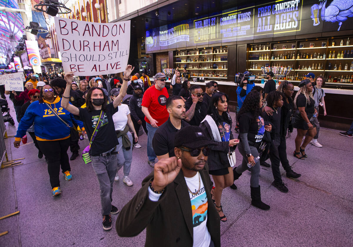 People march along the Fremont Street Experience during a rally for Brandon Durham, who was sho ...