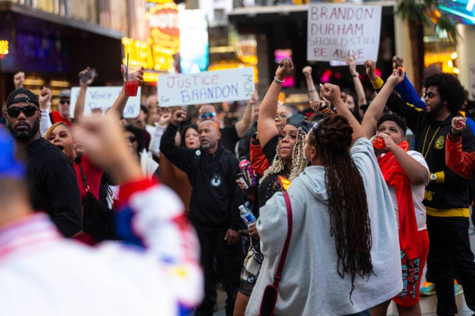 People march along the Fremont Street Experience during a rally for Brandon Durham, who was sho ...