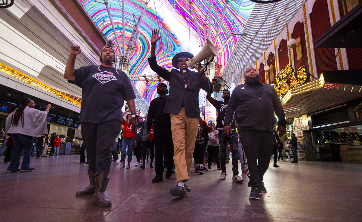 Minister Vance “Stretch” Sanders leads a march along the Fremont Street Experienc ...