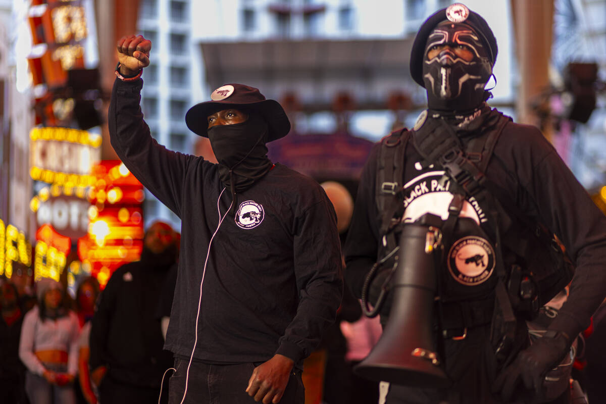 People march along the Fremont Street Experience during a rally for Brandon Durham, who was sho ...