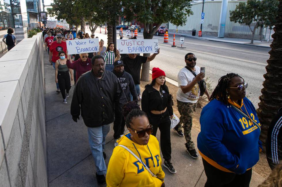 People march along Main Street during a rally for Brandon Durham, who was shot and killed by po ...