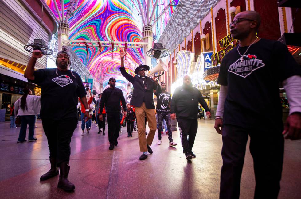 Minister Vance “Stretch” Sanders leads a march along the Fremont Street Experienc ...