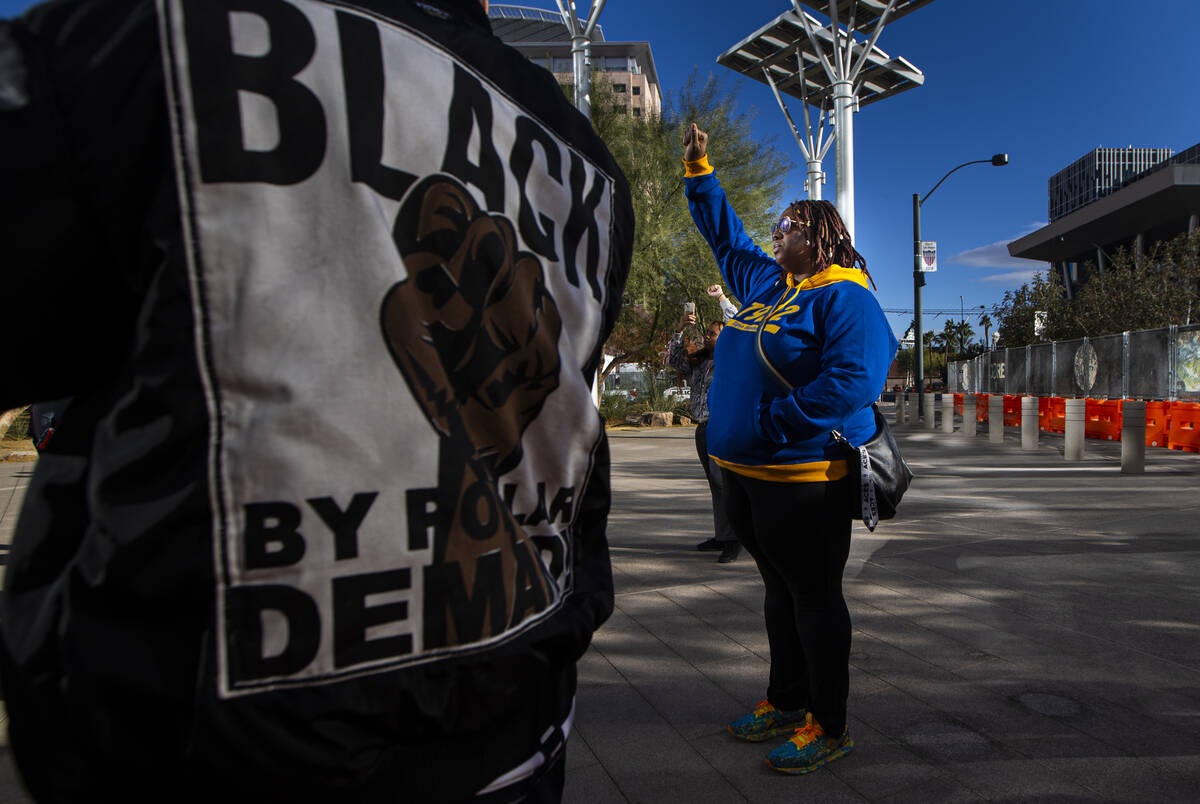 People participate in a rally for Brandon Durham, who was shot and killed by police in his own ...