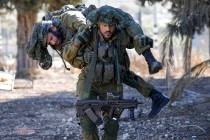 An Israeli soldier carries a comrade as they train while keeping a position in the upper Galile ...