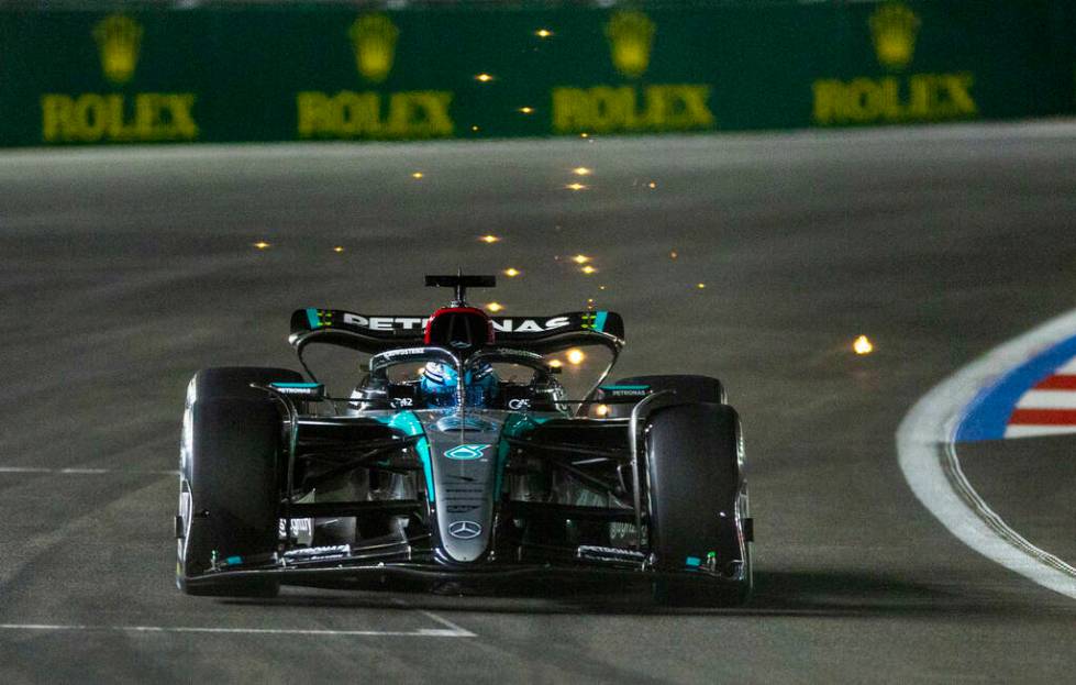 Mercedes driver George Russell sends some sparks flying while in the final turn on the track du ...