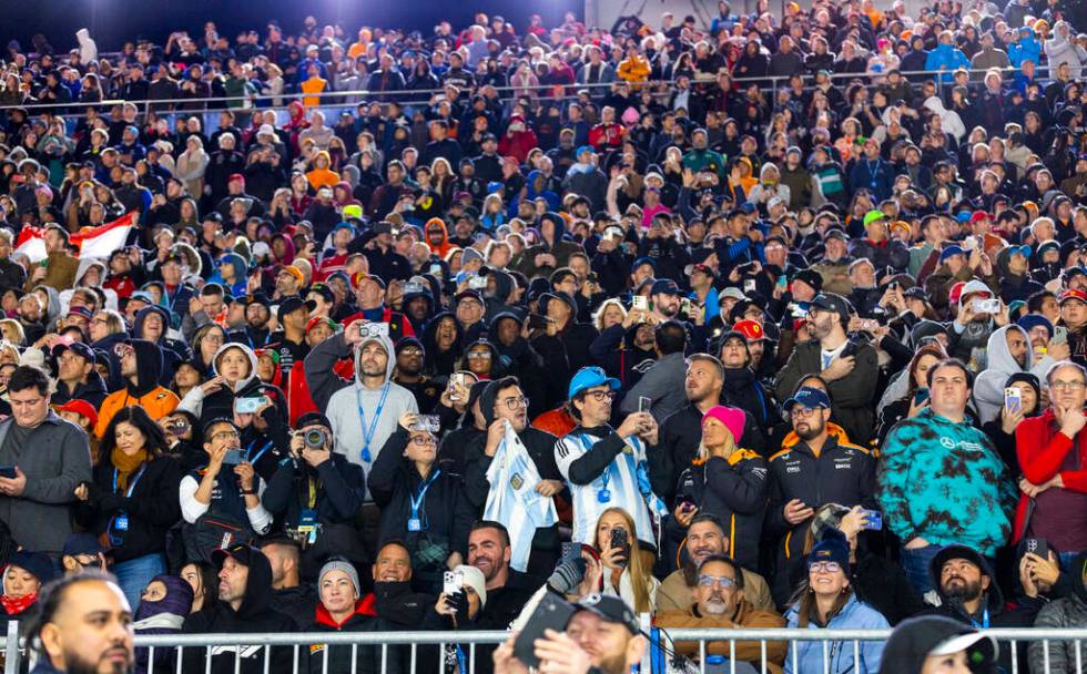 Fans stand for the finish of the race during the Formula 1 Las Vegas Grand Prix on Sunday, Nov. ...