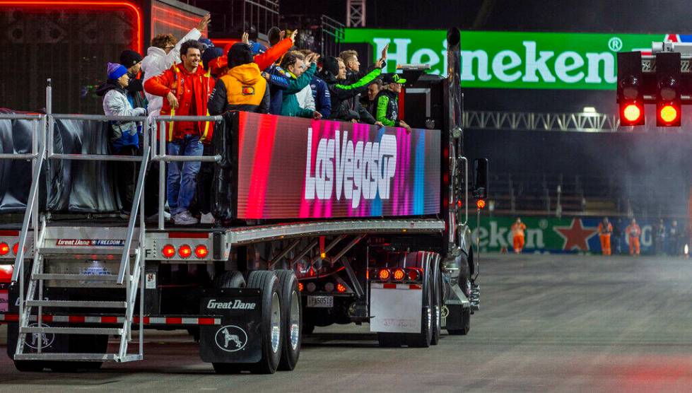 Drivers wave to fans as they take a lap after being introduced before the start of the Formula ...