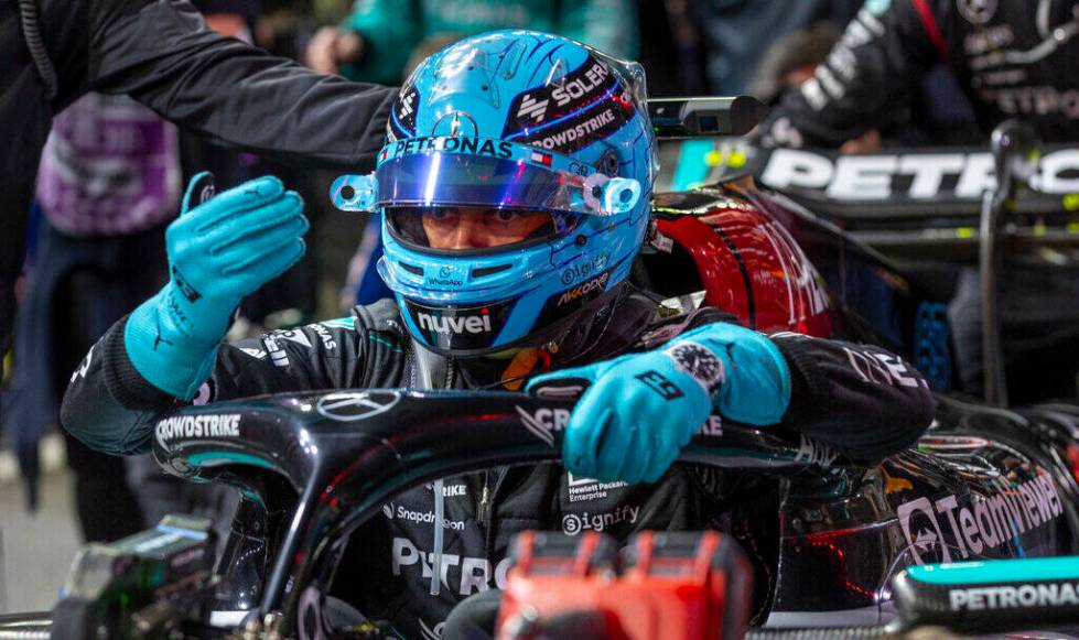 Mercedes driver George Russell signals a technician while in his car before the start during th ...