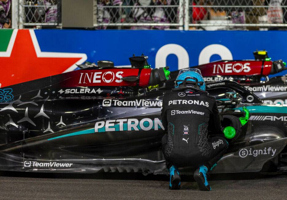 Mercedes driver George Russell takes quiet moment beside his race car after his race win at the ...