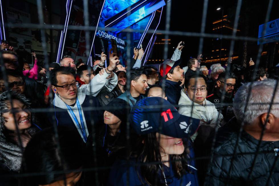 Formula 1 fans without tickets enjoy their view after parts of screens were torn down during th ...