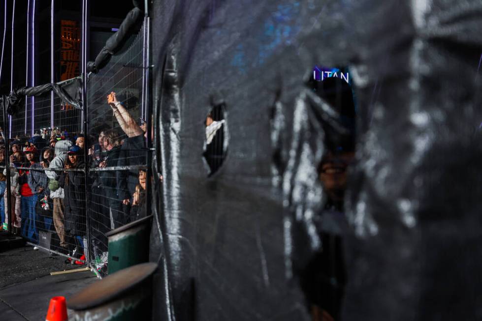 Formula 1 fans without tickets enjoy their view after parts of screens were torn down during th ...