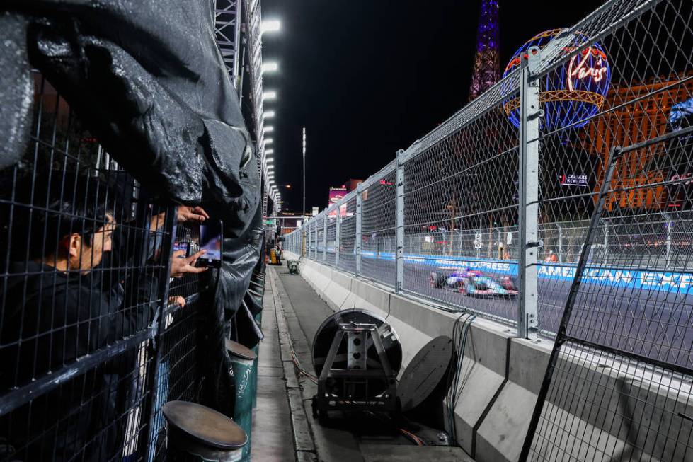 Formula 1 fans without tickets enjoy their view after parts of screens were torn down during th ...