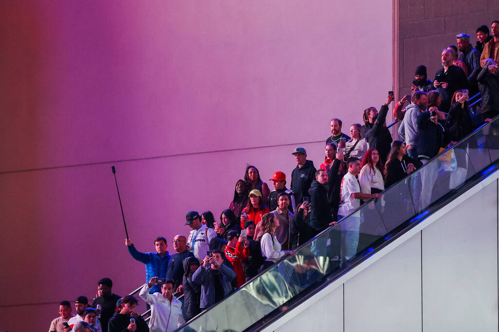 Formula 1 fans ride up and down an escalator to get a better view of the race during the Formul ...