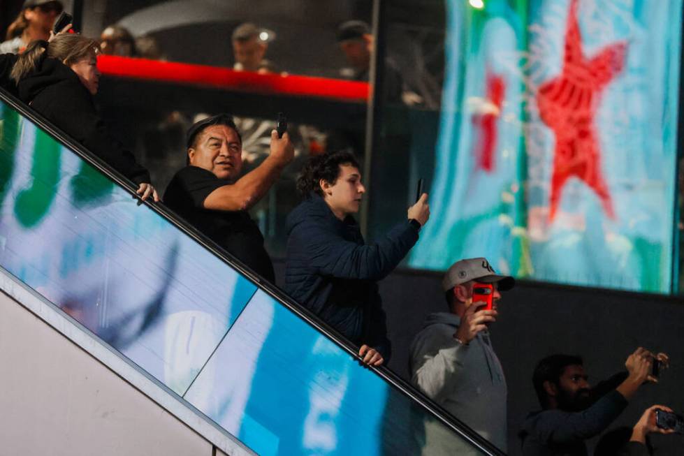 Formula 1 fans ride up and down an escalator to get a better view of the race during the Formul ...