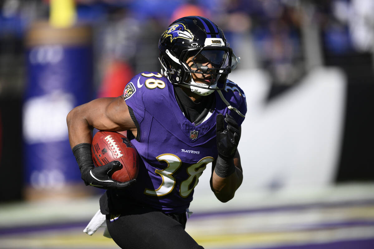 Baltimore Ravens running back Chris Collier (38) works out before an NFL football game against ...