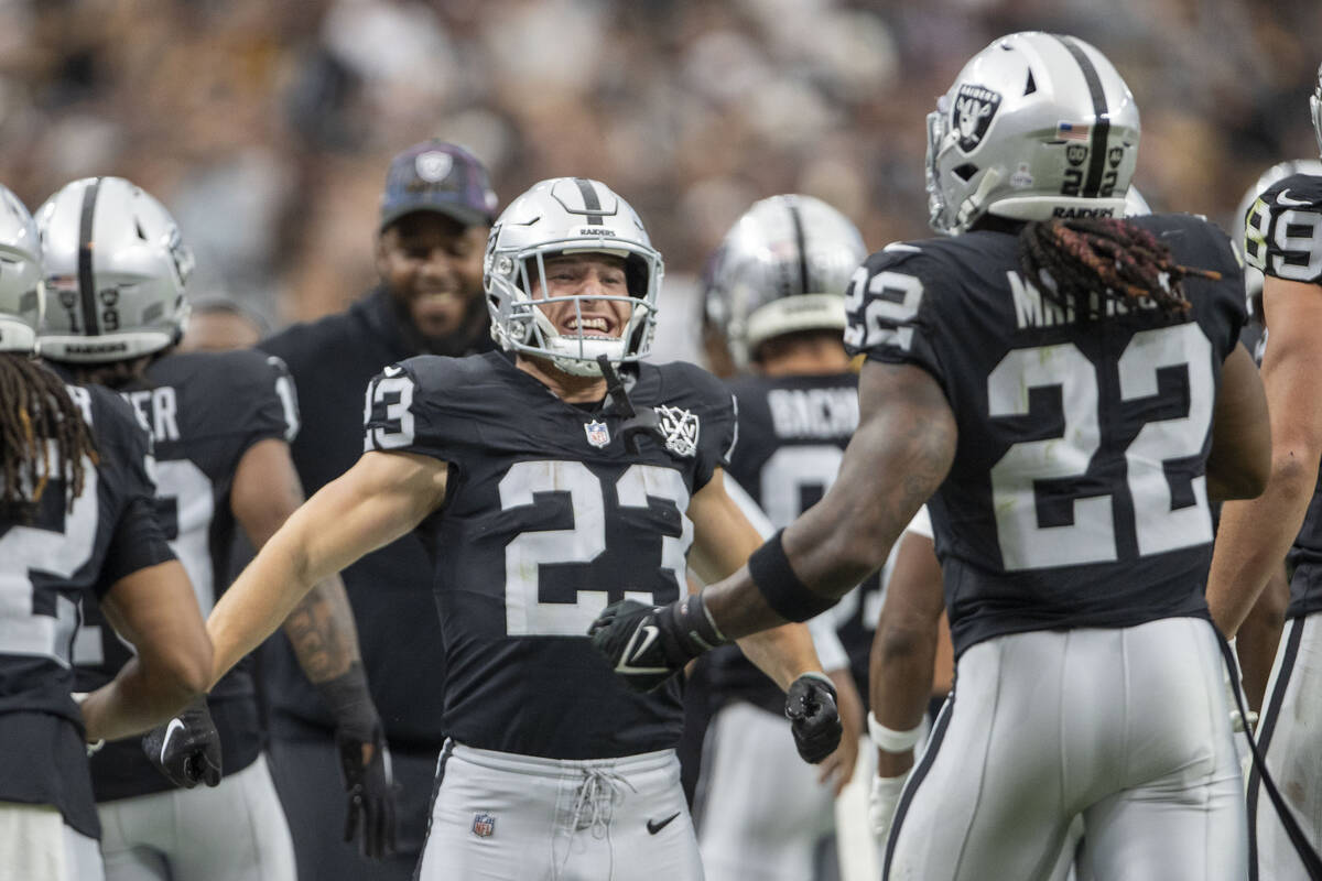 Raiders running back Dylan Laube (23) welcomes running back Alexander Mattison (22) back to the ...