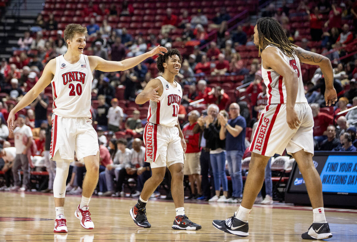 UNLV guard Julian Rishwain (20) and guard Dedan Thomas Jr. (11) look to celebrate a play with f ...