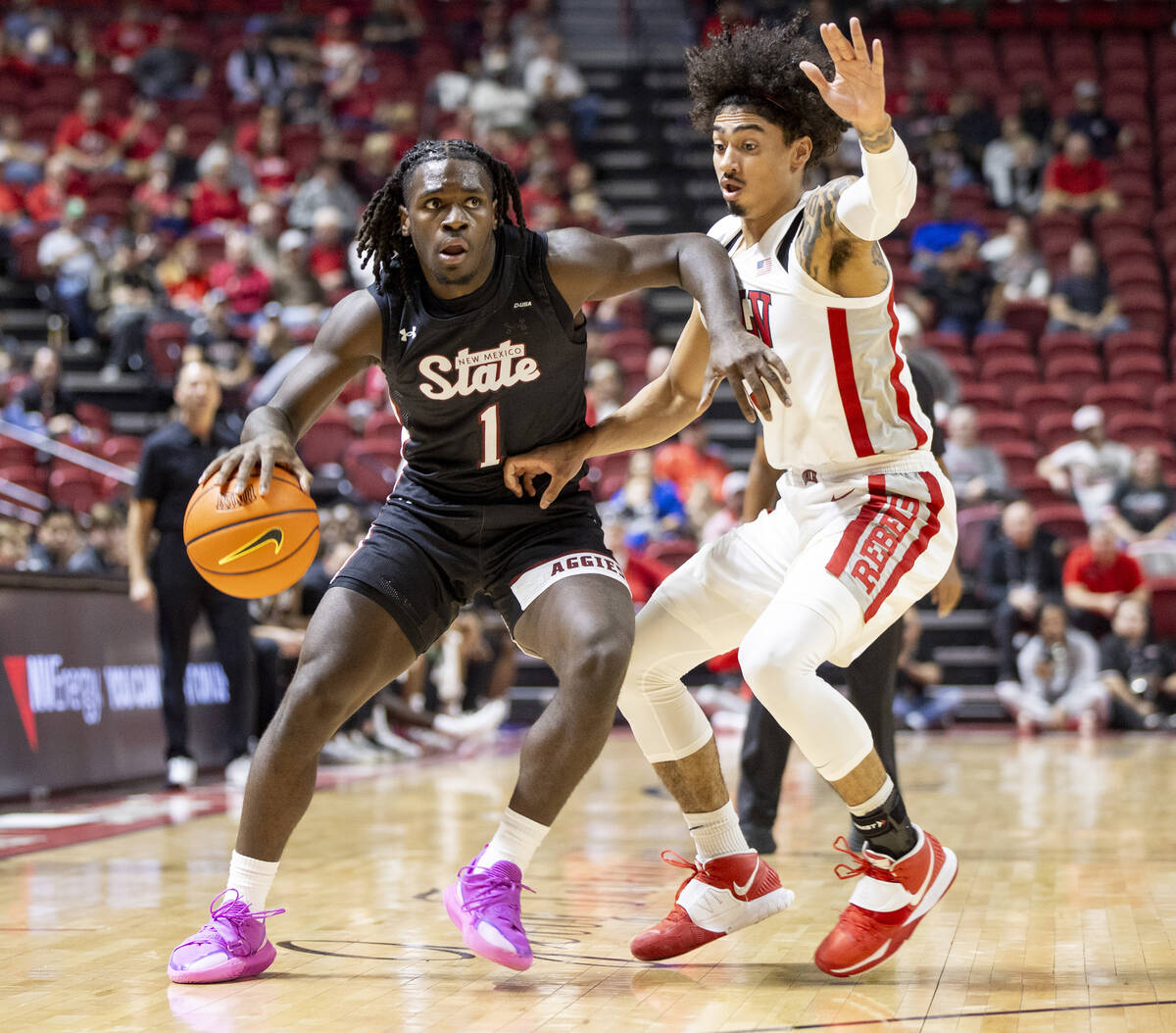 UNLV guard Brooklyn Hicks, right, guards New Mexico State Aggies guard Gabe Pickens (1) during ...