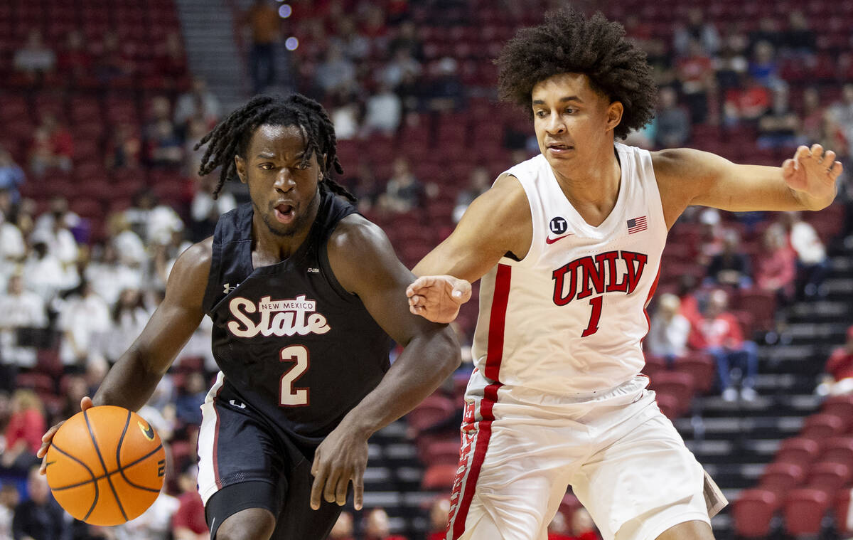 UNLV forward Jalen Hill (1) guards New Mexico State Aggies guard Zawdie Jackson (2) during the ...