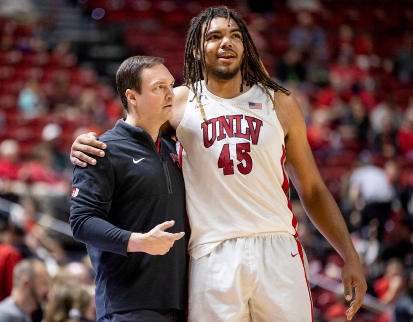 UNLV head coach Kevin Kruger and forward Jeremiah Cherry (45) hug during the college basketball ...