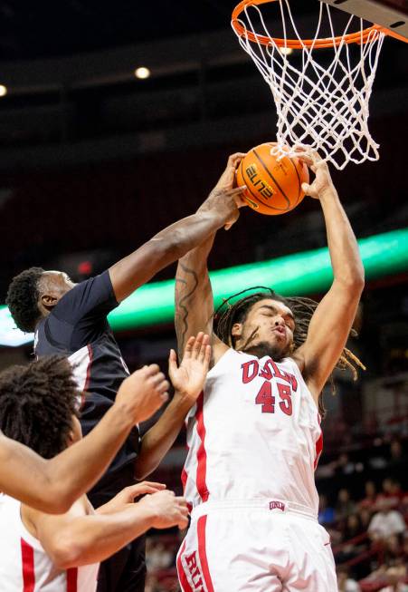 UNLV forward Jeremiah Cherry (45) grabs a rebound during the college basketball game against th ...