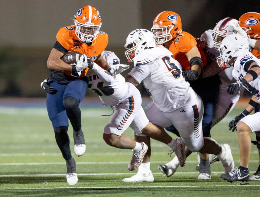 Bishop Gorman running back Terrance Grant (3) avoids tacklers during the Class 5A Division I st ...